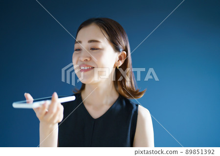 A woman talking on a smartphone A woman talking on a smartphone 89851392