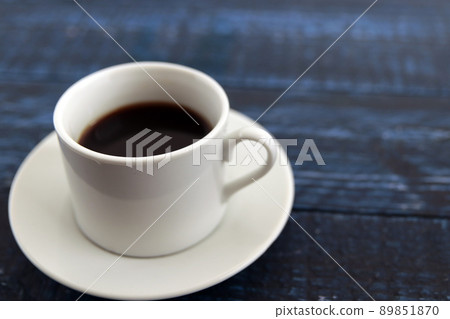 Black coffee in a co-e cup on a blue table 89851870