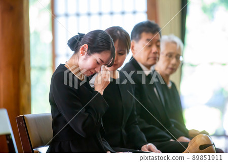 Bereaved family (female) crying at a funeral 89851911