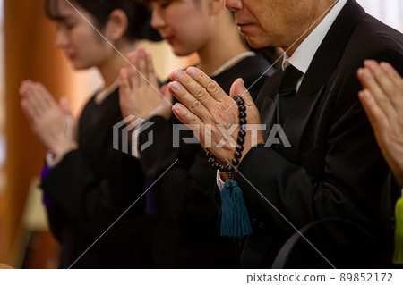 Bereaved family of mourning dress attending the funeral (no face) 89852172