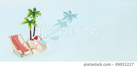 Toy beach deck chair and palm tree with sand on bleu background. Creative summer beach concept. 89852227