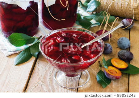 Plum canned plum juice cans on a wooden table 89852242