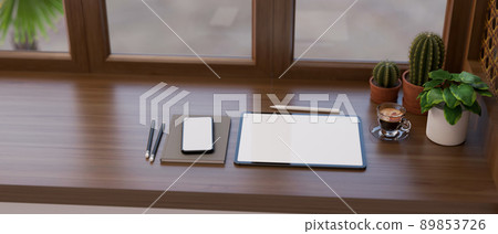 Workspace with a tablet mockup, smartphone and decor plants on modern classic wood tabletop 89853726