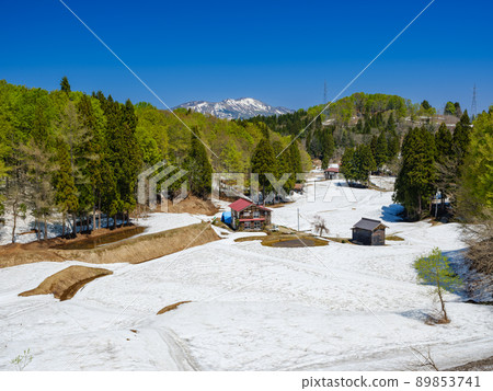 Niigata_ Superb view of terraced rice fields and Mt. Kurohime with remaining snow 89853741