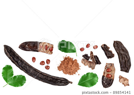 Ripe carob pods and bean isolated on white background with clipping path. Top view with copy space for your text. Flat lay Ripe carob pods and bean isolated on white background with clipping path. Top view with copy space for your text. Flat lay 89854141