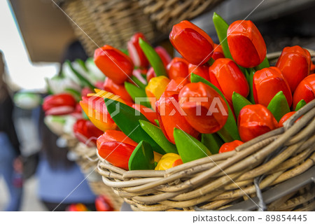 Lisse, Netherlands, April 2022. Clogs and wooden tulips, souvenirs of Holland. Lisse, Netherlands, April 2022. Clogs and wooden tulips, souvenirs of Holland. 89854445