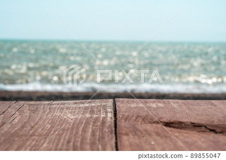 Abstract nature summer or spring ocean sea background. Small waves on golden warm water surface in motion blur with bokeh lights from sunset. Holiday, vacation and recreational background concept Abstract nature summer or spring ocean sea background. Small waves on golden warm water surface in motion blur with bokeh lights from sunset. Holiday, vacation and recreational background concept 89855047
