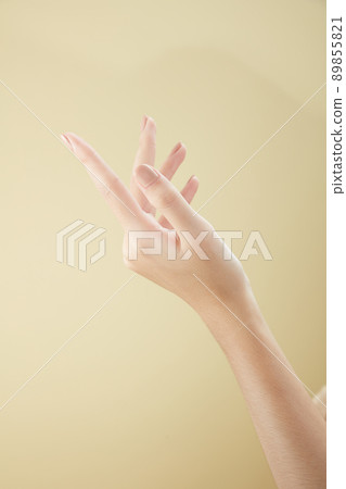 A front view of hand posing in beige background for cosmetic advertising 89855821