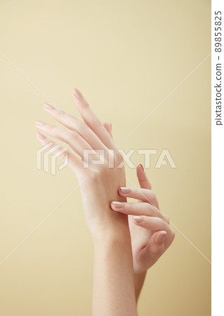 A front view of hand posing in beige background for cosmetic advertising 89855825