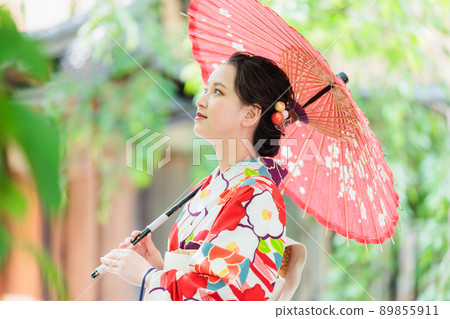 A young woman in a kimono holding a Japanese umbrella A young woman in a kimono holding a Japanese umbrella 89855911
