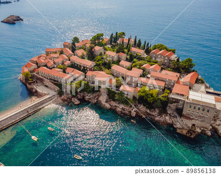 Aerophotography. View from flying drone. Panoramic view of Sveti Stefan island in Budva in a beautiful summer day, Montenegro. Top View. Beautiful destinations Aerophotography. View from flying drone. Panoramic view of Sveti Stefan island in Budva in a beautiful summer day, Montenegro. Top View. Beautiful destinations 89856138