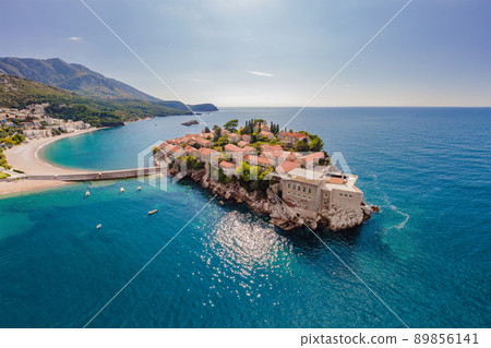 Aerophotography. View from flying drone. Panoramic view of Sveti Stefan island in Budva in a beautiful summer day, Montenegro. Top View. Beautiful destinations 89856141