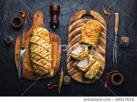 Wellington pork, pork tenderloin baked with mushrooms in puff pastry. 89857628
