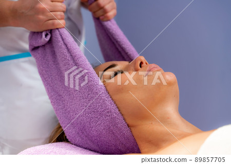 Relaxing massage. European woman getting head massage in spa salon, side view Relaxing massage. European woman getting head massage in spa salon, side view 89857705