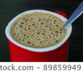 Red cup of coffee with white foam 89859949