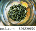 Dry black Tea leaves in glass bottle top view 89859950