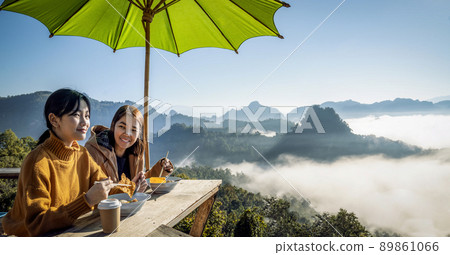 Asian traveller with camera take photo for a fog on a mountain at Japo village  89861066