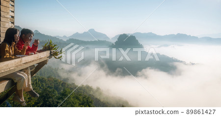 Asian traveller with camera take photo for a fog on a mountain at Japo village with a set of coffee and tea 89861427