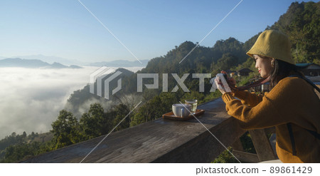 Asian traveller with camera take photo for a fog on a mountain at Japo village  89861429