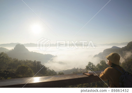 Asian traveller with camera take photo for a fog on a mountain at Japo village Asian traveller with camera take photo for a fog on a mountain at Japo village 89861432