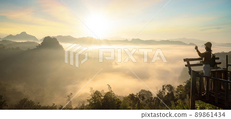 Asian traveller with camera take photo for a fog on a mountain at Japo village 89861434