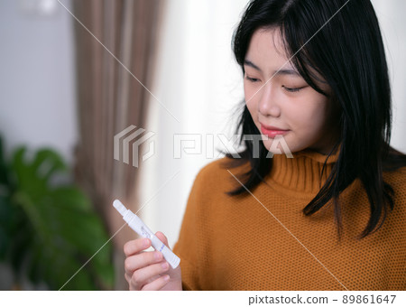 Asian lady check covid19 coronavirus omicron by use soliva antigen test kid by her self Asian lady check covid19 coronavirus omicron by use soliva antigen test kid by her self 89861647