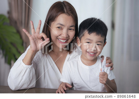 Mother test covid19 for her son with saliva ATK at they home Mother test covid19 for her son with saliva ATK at they home 89861648
