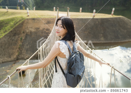 Asian girl travel and walk on the bridge 89861743