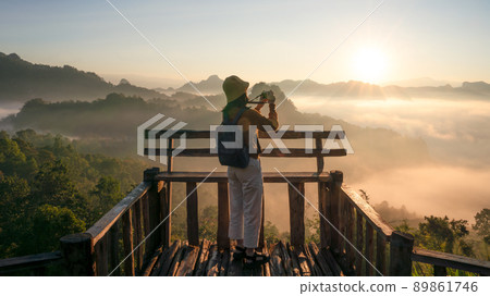 Asian traveller with camera take photo for a fog on a mountain at Japo village Asian traveller with camera take photo for a fog on a mountain at Japo village 89861746