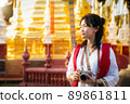 Asian traveller with camera on hand and vintage costume walking in Chiang mai city 89861811