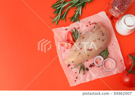Raw chicken fillet with ingredients on orange background 89862007