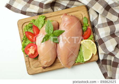 Concept of tasty food with slices of raw chicken fillet on white background Concept of tasty food with slices of raw chicken fillet on white background 89862025