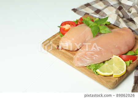 Concept of tasty food with slices of raw chicken fillet on white background Concept of tasty food with slices of raw chicken fillet on white background 89862026