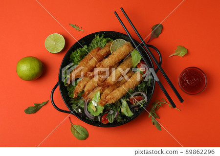 Concept of tasty food with deep-fried shrimp on orange background Concept of tasty food with deep-fried shrimp on orange background 89862296