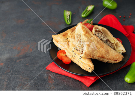Concept of tasty food with samsa on dark textured background 89862371