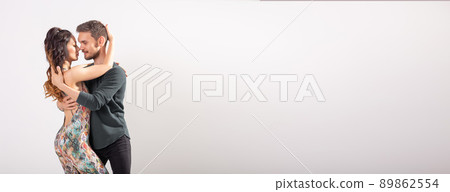 Skillful dancers performing sensual couple an artistic and emotional contemporary dance kizomba bachata or semba salsa or taraxia on white background banner with copy space banner and place for text Skillful dancers performing sensual couple an artistic and emotional contemporary dance kizomba bachata or semba salsa or taraxia on white background banner with copy space banner and place for text 89862554