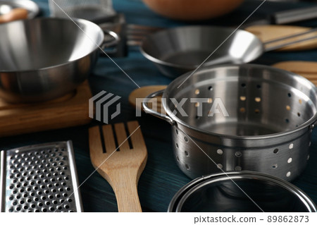 Different kitchen utensil on blue wooden background 89862873