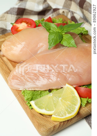 Concept of tasty food with slices of raw chicken fillet on white background 89862927