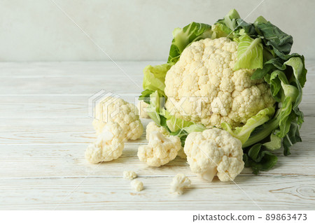Fresh juicy cauliflower with slices on wooden background Fresh juicy cauliflower with slices on wooden background 89863473