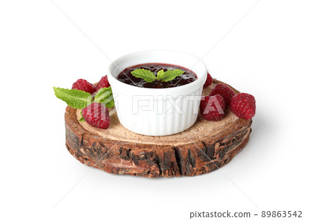 Bowl of raspberry jam on a wooden stand, isolated on  white background 89863542