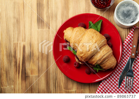 Concept of delicious food with croissant with raspberry jam on wooden background 89863737
