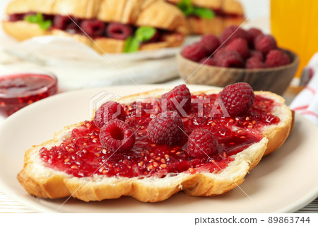 Concept of delicious food with croissants with raspberry jam on white wooden background 89863744