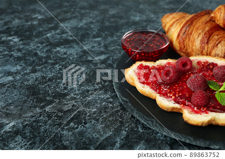 Concept of delicious food with croissants with raspberry jam on black smokey background Concept of delicious food with croissants with raspberry jam on black smokey background 89863752
