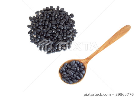 Closeup black beans seeds wooden spoon on white background, healthy food concept 89863776