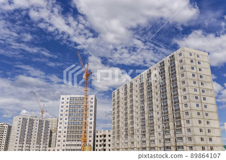 Construction of multistorey building and big cranes Construction of multistorey building and big cranes 89864107