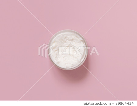Homemade cream in plastic jar on light pink top view. Brand packaging mockup 89864434