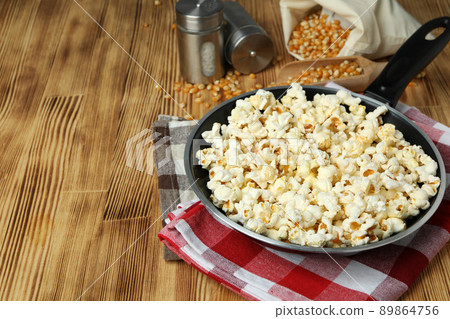 Concept of homemade popcorn on wooden background Concept of homemade popcorn on wooden background 89864756