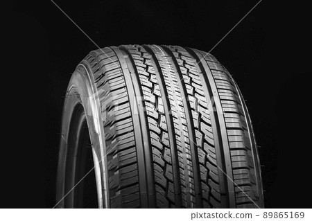 all-season new tire on a black background 89865169