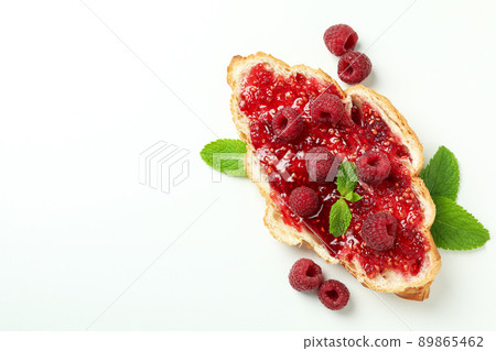 Croissant with raspberry jam on white background 89865462