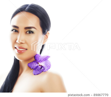 young pretty asian woman with flower purple orchid close up isolated on white background spa smiling casual 89867770